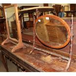 A 19th century mahogany oval dressing table mirror with turned supports; together with an