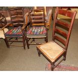 A 19th century elm ladder back armchair; together with a further elm ladder back dining chair; and a