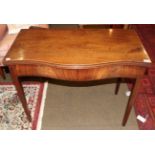 A George III mahogany serpentine shaped tea table, fold-over top, inlaid shell paterae, square