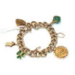 A curb and lock bracelet, stamped '9' and '.375', hung with four charms including a 1910 half