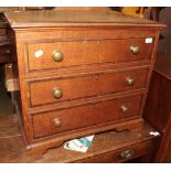 An oak and mahogany crossbanded chest with hinged top, modelled as a chest of drawers
