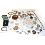 A small quantity of costume jewellery to include silver rings, brooches, a compact, pendant on