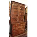 A 19th century mahogany bookcase, the glazed upper section decorated with blind fret-work over a