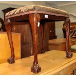 A George III style stool with needlework top, raised on cabriole legs, with ball and claw feet