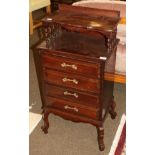 An early 20th century four drawer chest with spindle turned shelf