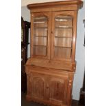 An late 19th/early 20th century pine bureau bookcase with shaped apron; and a four leaf printed