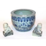 A Chinese blue and white fish bowl and a pair of carved green stone temple lions