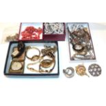 A quantity of costume jewellery including brooches, a coral necklace, wristwatches, earrings etc