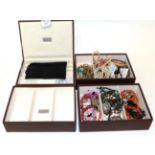 A collection of silver and costume jewellery including brooches, beads, bangles etc, in a