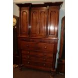 A 19th century oak inverted break front linen press