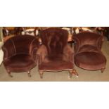 A Victorian button back nursing chair; together with two tub chairs upholstered in brown fabric (a.