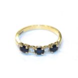 An 18 carat gold sapphire and diamond ring, finger size N. Gross weight 2.3 grams.