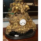 A French gilt metal striking mantel clock, the elaborate case surmounted by a gentleman leaning on