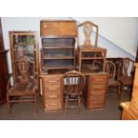 An Edwardian oak tambour fronted desk; together with three Chippendale style oak dining chairs;