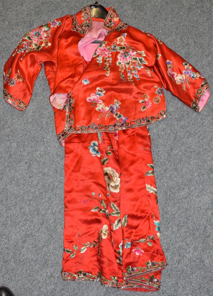 A circa 1930s Chinese red silk tunic and skirt, embroidered with prunus with a later sequin trim