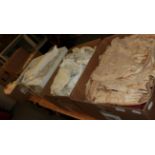 A large quantity of assorted white cotton and linen bed and table wares, lace curtains,