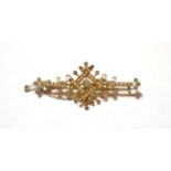 An Edwardian split pearl and diamond brooch, the central old cut diamond in a yellow collet setting,