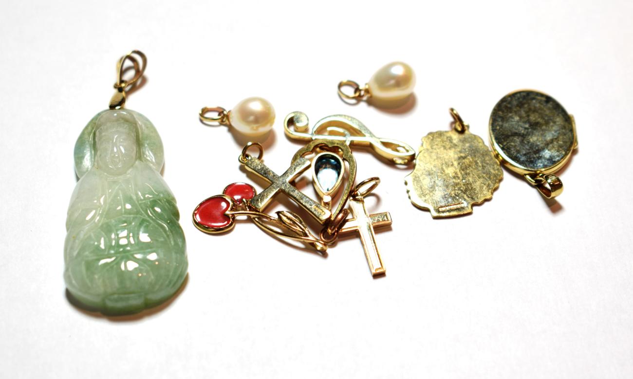 Six 9 carat gold charms/pendants including two crosses, a locket, a branch of cherries etc; a