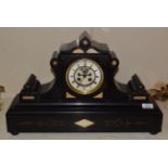 A Victorian black slate striking mantel clock