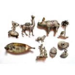 A collection of silver and metalware toys and miniatures, comprising: a filigree rhinoceros, the