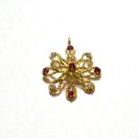 A ruby and diamond pendant, stamped '750', length 3.4cm . Gross weight 6.0 grams.