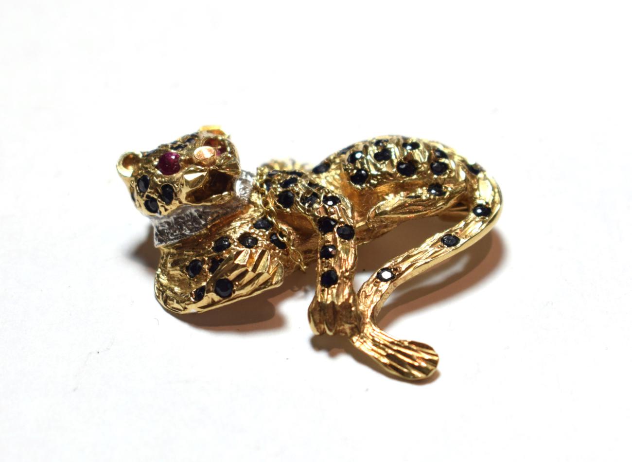 A 9 carat gold gem set brooch in the form of a leopard, length 3.7cm. Gross weight 10.9 grams.