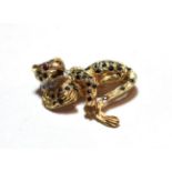 A 9 carat gold gem set brooch in the form of a leopard, length 3.7cm. Gross weight 10.9 grams.