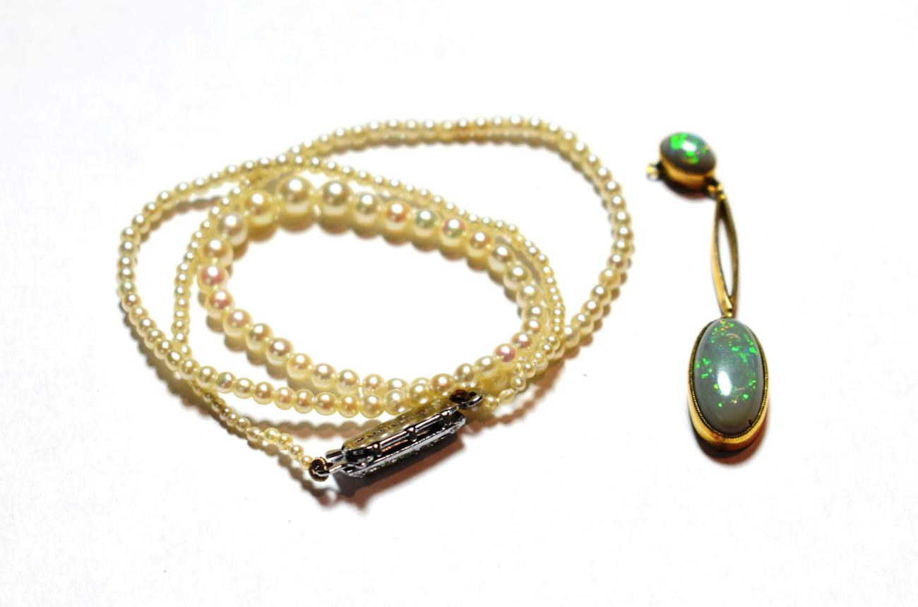 A cultured pearl necklace with a marcasite set clasp, length 38cm; and an opal drop, stamped '
