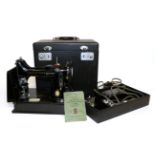 A Singer Portable Sewing Machine No 221K1, together with accessories including the rubber
