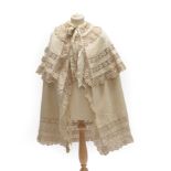 An Edwardian Cream Silk Grosgrain Cape, with a cream silk floral trim insertions and edgings,