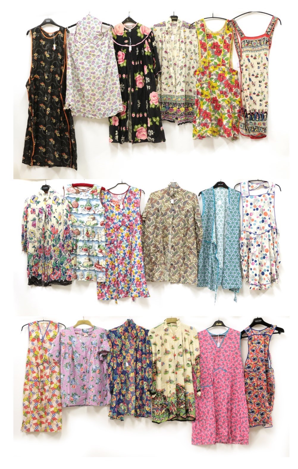 Eighteen Assorted Circa 1930's-1950's Printed Cotton Aprons and Housecoats, including a Conquestor