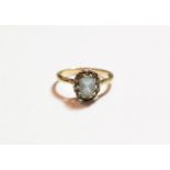 A 9 carat gold aquamarine and diamond cluster ring, finger size L. Gross weight 2.2 grams