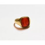 An 18 carat gold cornelian signet ring, finger size O. Gross weight 8.8 grams.