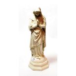 A Belleek porcelain figure modelled as the Virgin Mary on a dome shaped stepped octagonal base,