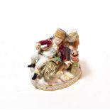 An early 20th century Meissen figural group of two children cutting wood