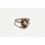 A cultured pearl and diamond cluster ring, stamped '9CT', finger size P. Gross weight 3.0 grams.