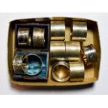 Eleven various silver napkin-rings, including: a pair in fitted case; a set of five engine turned