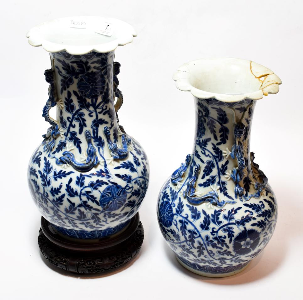 A pair of 19th century Chinese blue and white vases (one a.f.); together with a hardwood stand (3)