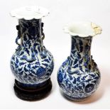 A pair of 19th century Chinese blue and white vases (one a.f.); together with a hardwood stand (3)