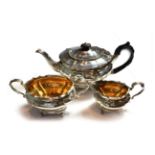A three-piece Victorian silver tea-service, by Charles Stuart Harris, London, 1898, retailed by Reid