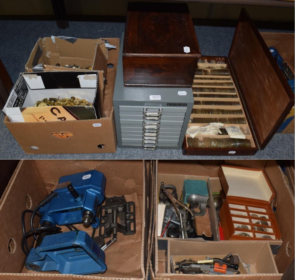 A watchmaker's wooden box containing a large quantity of pocket watch glasses; watchmaker's parts