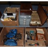 A watchmaker's wooden box containing a large quantity of pocket watch glasses; watchmaker's parts