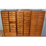 Three small watchmaker's drawer cabinets containing watch parts; stems; staffs; hands; winding