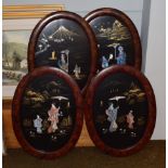 A set of four Japanese lacquered oval panels depicting figures