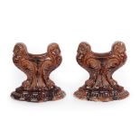 A Pair of Doulton Lambeth Stoneware Fire Rests, each modelled with two stylised owls, brown