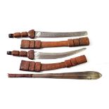 Two Tuareg Short Swords, each with curved double edge steel blade stamped with roundels and