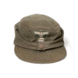 A German Third Reich SS EM's M43 Field Cap, in grey/green wool, with BeVo woven SS eagle and skull
