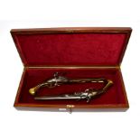 A Good Pair of Non-working Copies of Flintlock Pistols, each with a 30cm round steel barrel,