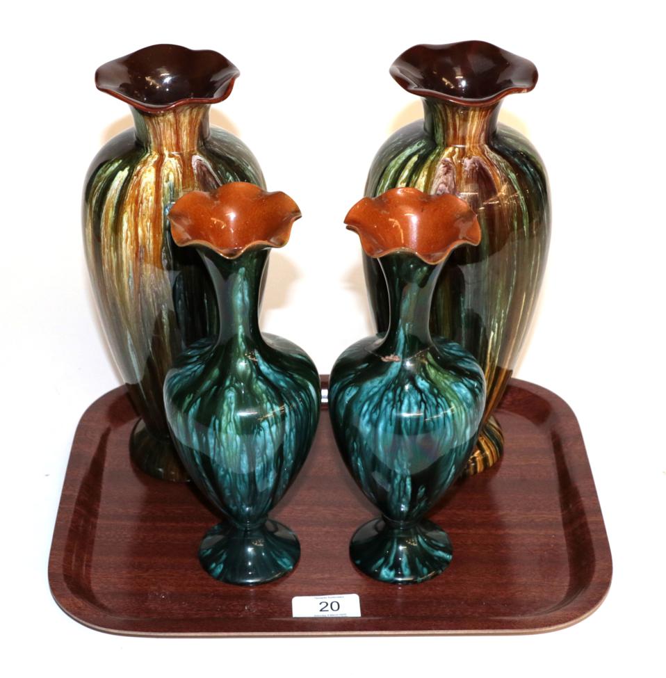 A pair of Linthorpe pottery vases, shape 998, both with retailers label 'Dickinson & Benson