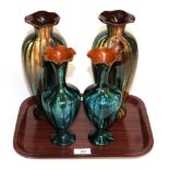 A pair of Linthorpe pottery vases, shape 998, both with retailers label 'Dickinson & Benson